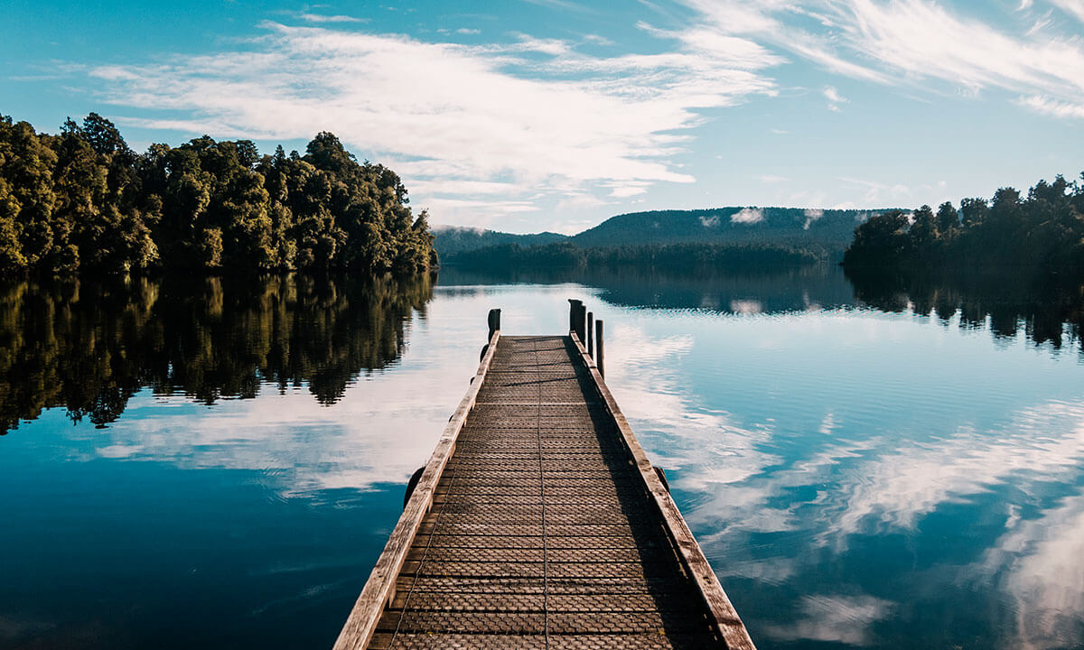 Empty dock on a lake representing the isolating experience of paruresis